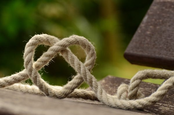 brown-rope-tangled-and-formed-into-heart-shape-on-brown-113737-min