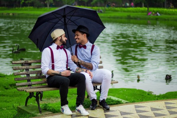 two-man-with-umbrella-sitting-on-bench-2442163-min